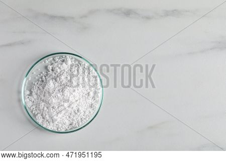 Petri Dish With Calcium Carbonate Powder On White Marble Table, Top View. Space For Text