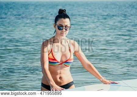 Sea Woman Sup. Silhouette Of Happy Middle Aged Tanned Woman In Rainbow Bikini, Surfing On Sup Board,