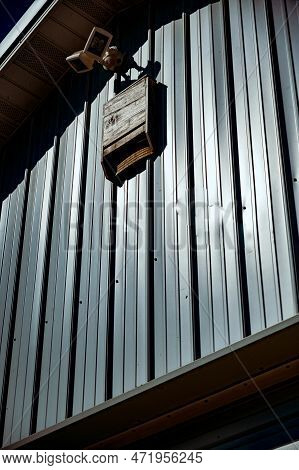 Wooden Bat House On White Corrugated Tin Barn