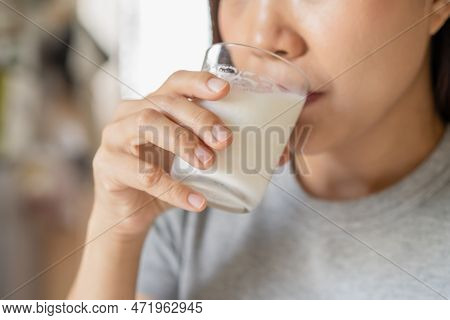 Happy, Asian Young Woman, Girl Drinking A Glass Of White Fresh, Warm Or Hot Dairy Milk For Calcium, 