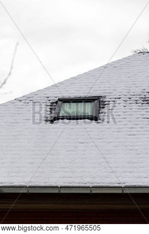 A Portrait Of A Slate Roof With Snow On It With A Skylight Window Which Is Surrounded By Snow During