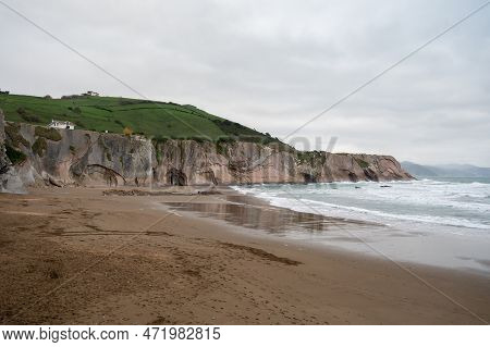 View On Sandy Beach, Rocks And Atlantic Ocean In Zumaia Touristic Ciry, Basque Country, Spain