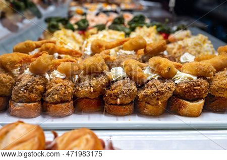 Typical Snack Of Basque Country, Pinchos Or Pinxtos, Small Piece Of Bread With Different Fish And Se