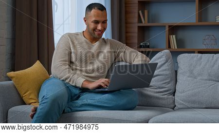 Millennial 30s African American Adult Man Ethnic Businessman Freelancer Sit On Couch Use Pc Laptop T