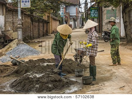 Turning Manually Sand, Water And Cement Into Mortar.