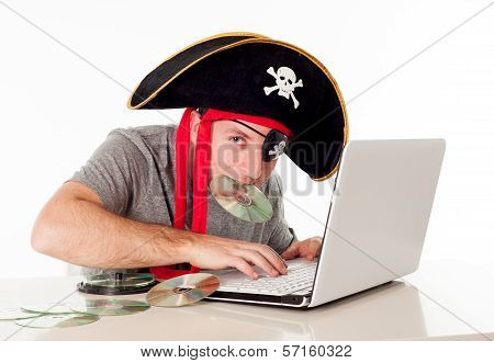 Man In Pirate Hat Downloading Music On A Laptop