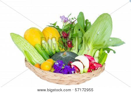 vegetables and fruits in wicker basket isolated on white