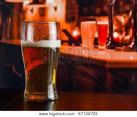 Glass Of Fresh Beer On Wood Table