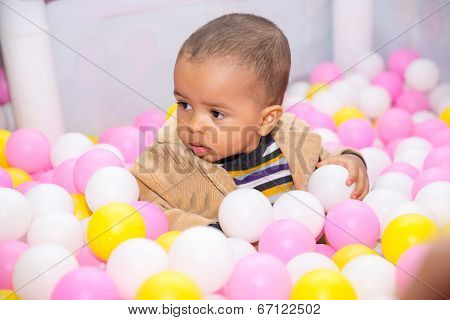 Happy Black Boy In Colored Ball On Birthday On Playground. The Concept Of Childhood And Holiday