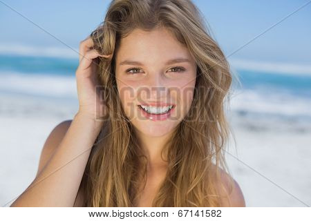 Beautiful happy blonde on the beach on a sunny day