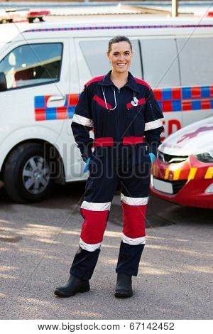 happy emergency medical service worker standing in front of ambulance