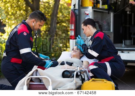team of paramedics rescuing young patient