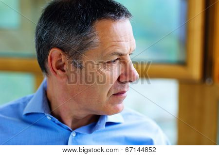 Senior man in glasses looking away