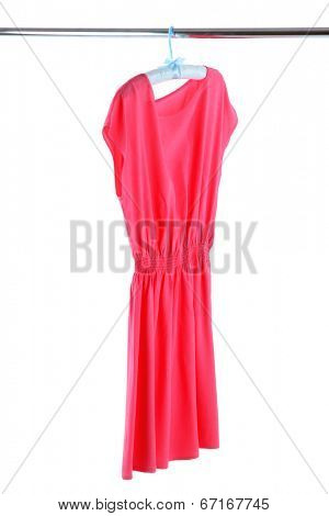 Beautiful pink dress hanging on hangers isolated on white