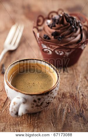 coffee and cupcake in rustic style on wooden table