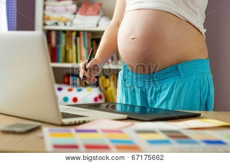 Pregnant woman working from home