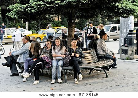 People sitting on a park bench in Bitola