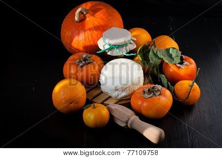 Persimmons, tangerines, oranges, cheese and pumpkin