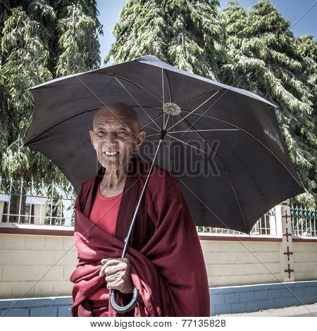 BYLAKUPPE, INDIA - FEB 10, 2013 : Buddhist monk in the Namdroling Monastery in Bylakuppe, Karnataka, India on February 10, 2013. Bylakuppe is one of the biggest Tibetan refugee settlements in India.
