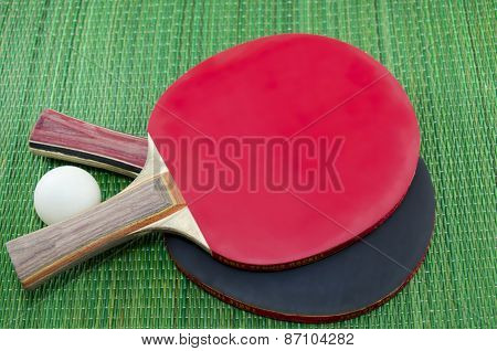 Two Table Tennis Rackets On Green Surface