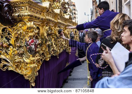 Boys Tries To Touch The Skirt Of The Throne To Have Good Luck, Popular Tradition In Andalusia, Easte