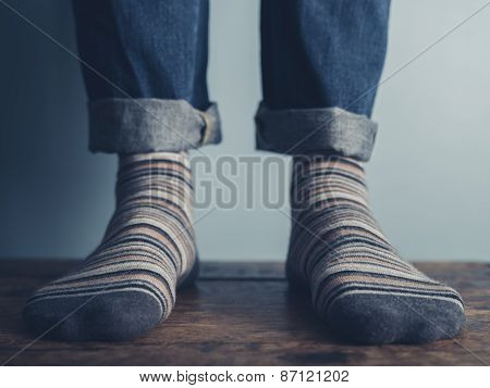 Feet Of A Man On Wooden Floor