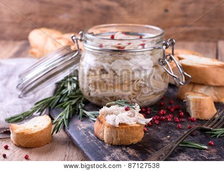 Chicken Pate In Glass Jar And Toast Bread On Rustic Kitchen Board