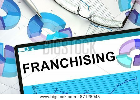 Franchising on tablet with graphs.