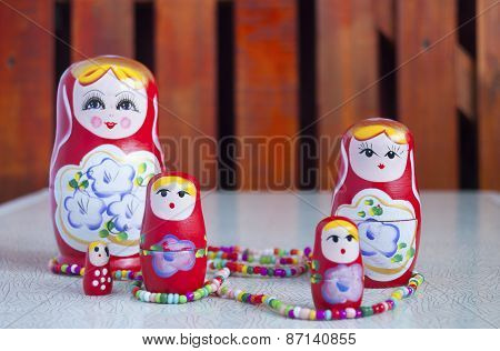 Five Dolls And Colored Beads On The Table