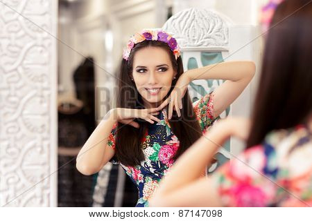 Beautiful Girl Looking in the Mirror and Trying on Floral Dress