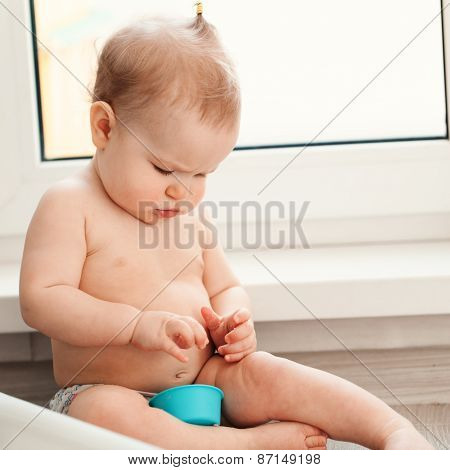 Little Girl Playing With Sand On Floor