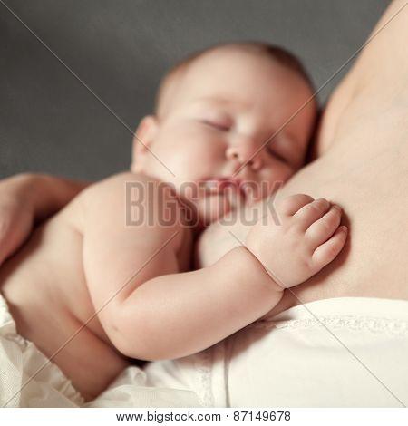 Palm Of Baby Girl On Mother's Breast