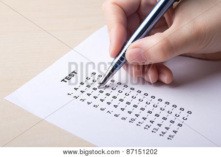 Woman Filling Test Sheet With Answers