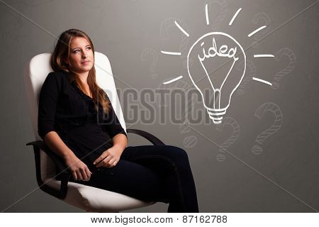 Pretty young girl comming up with a light bubl idea sign