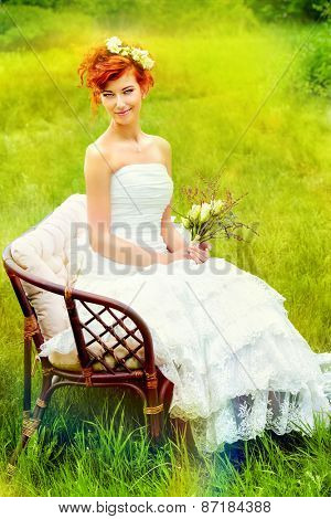 Beautiful smiling bride with chaming red hair. Wedding dress and accessories. Wedding decoration. 