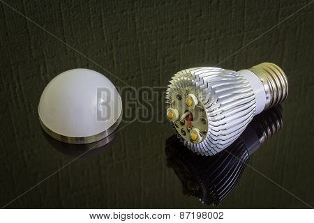 Close up disassembled Led Lamp on the black reflecting surface.