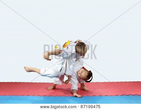 Throws on the mats are doing two athletes