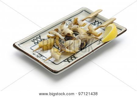 grilled skewered whelks, japanese food isolated on white background