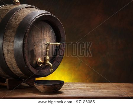 Old oak wine barrel on wooden table.