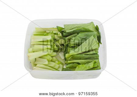 Fresh green vegetable in plastic box isolated on white backhround