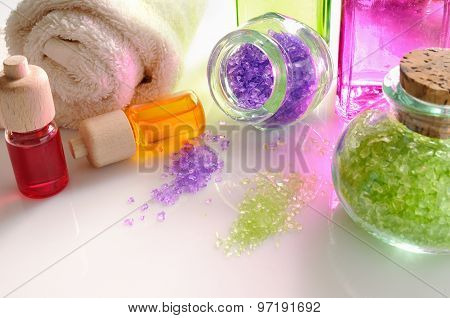 Oils And Bath Salts On White Glass Table Detail