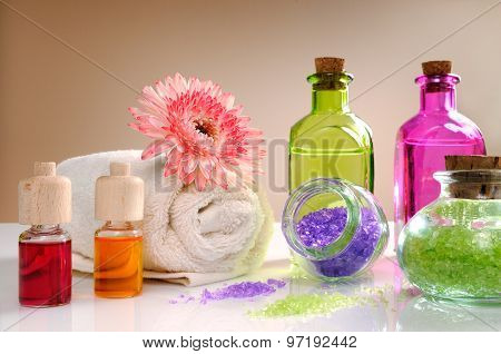 Oils And Bath Salts On White Table With Brown Background