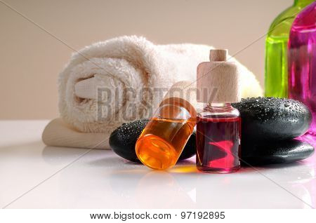 Oils Stones And Towel On White Table Front View