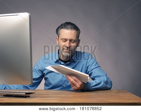 Handsome businessman with a paper plane start up or upswing concept