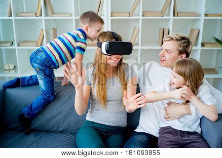 Happy family at home and playing with virtual reality goggles, VR headset, modern technology glasses
