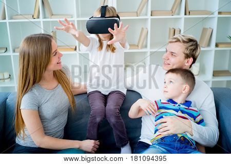 Happy family at home and playing with virtual reality goggles, VR headset, modern technology glasses