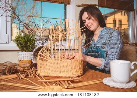 young pretty woman making baskets, home business
