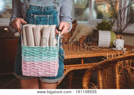 woman holds basket with sets for basketmaker close up