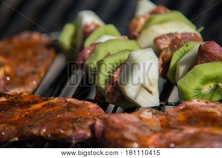Close On Raw Meat With Fruits On The Grill