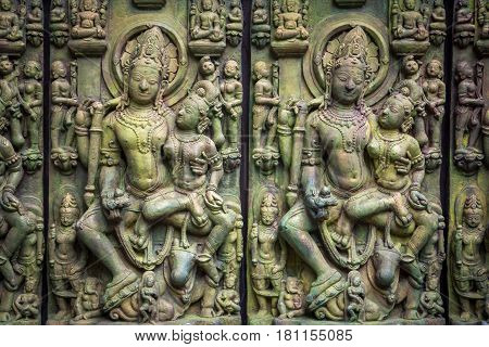 Traditional Asian stone carving of Buddhism deities illustrating Asian culture and Asian carving craft